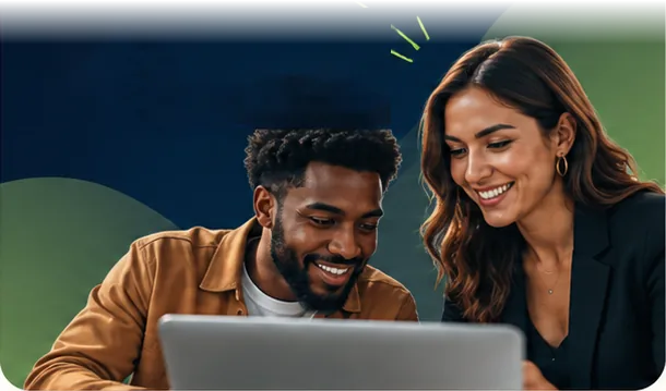 Two colleagues smiling at a laptop